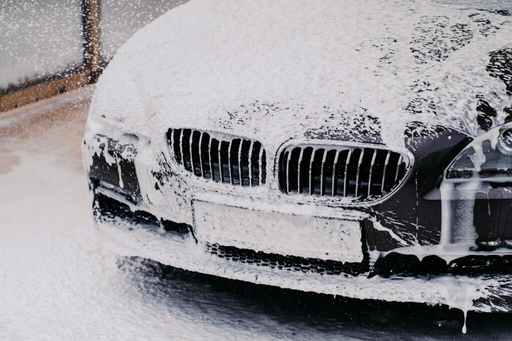 black car being washed with soap